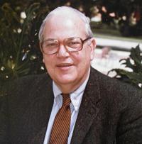 Headshot of Melvin Moss who is a white old man with spectacles. He is smiling at the camera